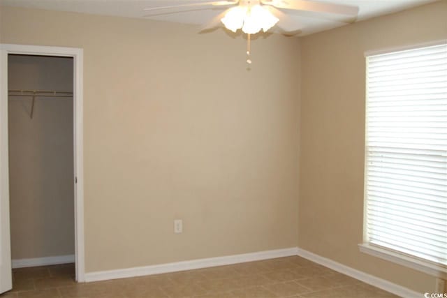 unfurnished bedroom with a closet, light tile patterned flooring, and ceiling fan