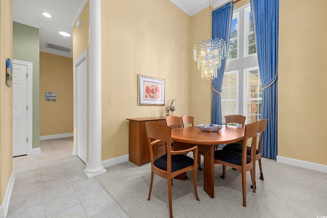 dining room featuring a chandelier, light tile patterned floors, crown molding, and decorative columns