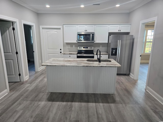 kitchen featuring wood-type flooring, a center island with sink, sink, white cabinets, and appliances with stainless steel finishes