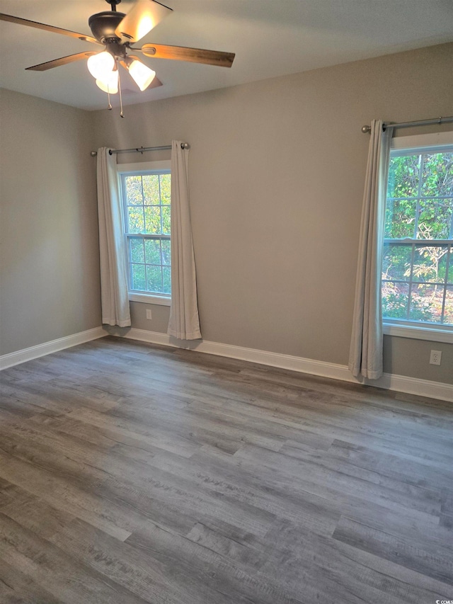 spare room featuring hardwood / wood-style flooring and ceiling fan