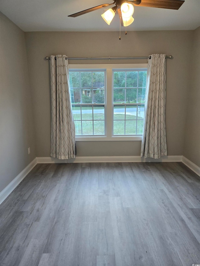 spare room with ceiling fan and hardwood / wood-style floors