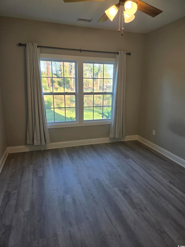 unfurnished room with dark wood-type flooring and ceiling fan