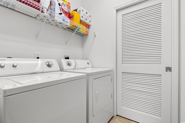 clothes washing area featuring washer and clothes dryer