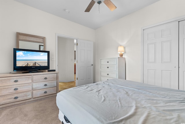 carpeted bedroom featuring a closet and ceiling fan