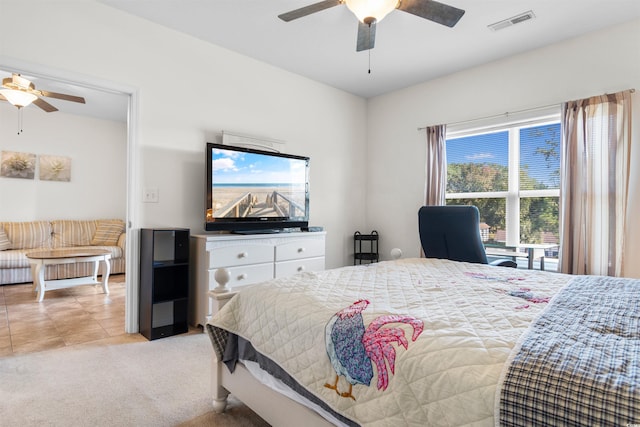 tiled bedroom featuring multiple windows and ceiling fan