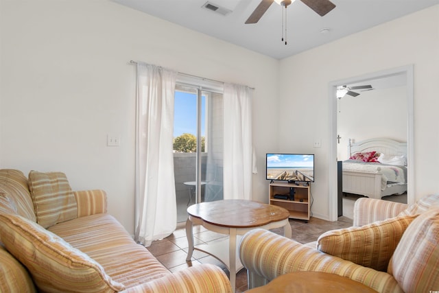 tiled living room with ceiling fan