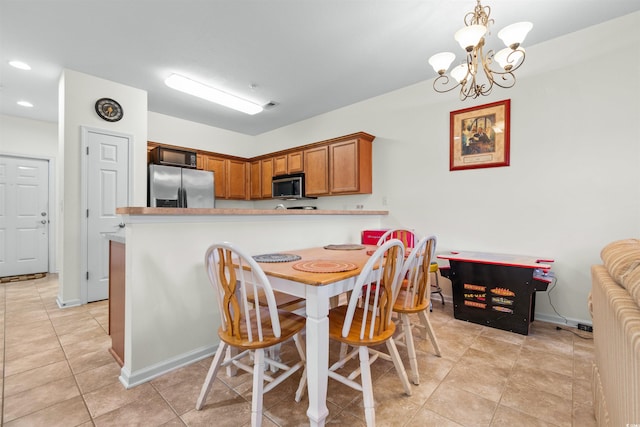 dining area featuring a notable chandelier and light tile patterned floors