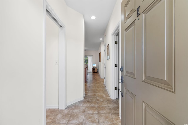 hall with light tile patterned floors