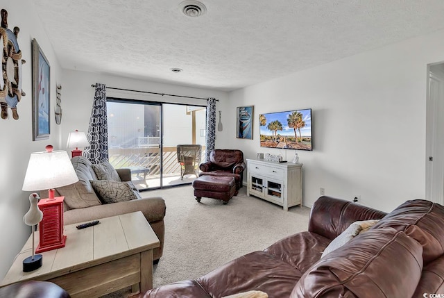 living room featuring a textured ceiling and carpet floors