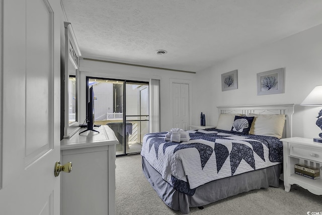 9621 Shore Dr Unit G219, Myrtle Beach, SC 29572 - bedroom featuring light colored carpet, access to outside, and a textured ceiling