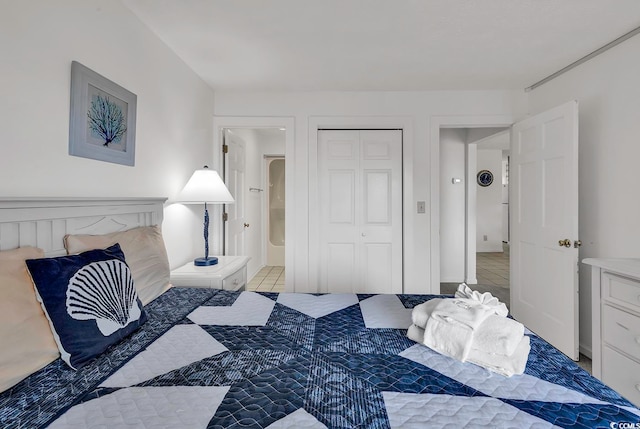 bedroom with a closet and light tile patterned flooring