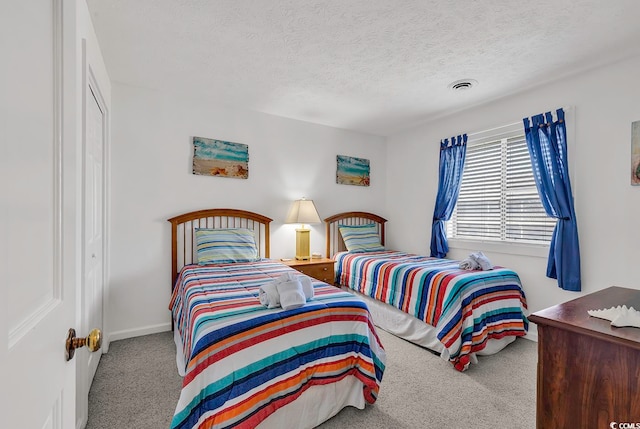 carpeted bedroom with a textured ceiling