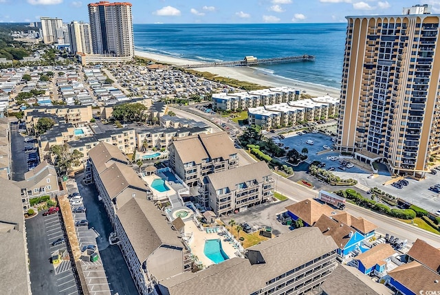 drone / aerial view featuring a water view and a view of the beach