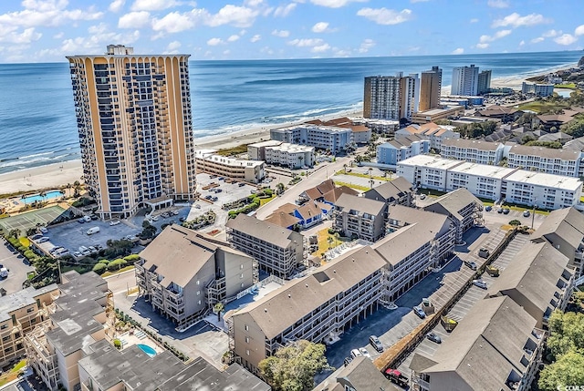 birds eye view of property featuring a water view and a beach view