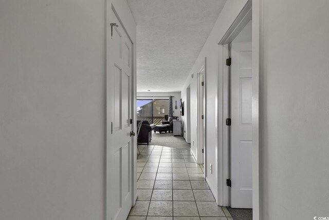 9621 Shore Dr Unit G219, Myrtle Beach, SC 29572 - hallway with a textured ceiling and light tile patterned floors