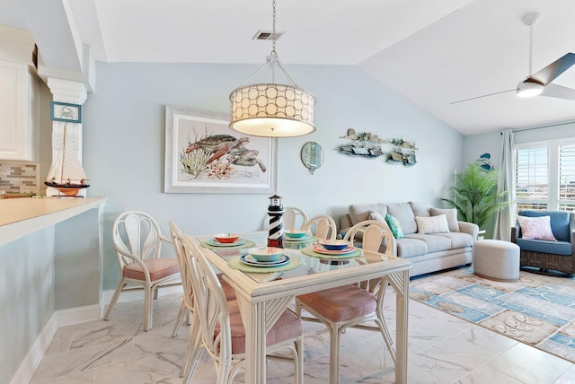 dining area featuring vaulted ceiling