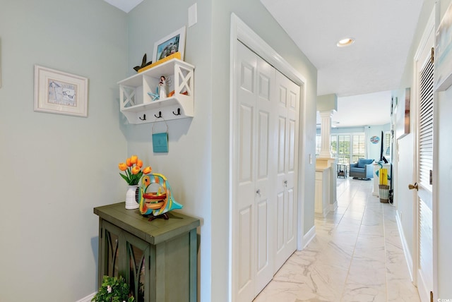 hallway featuring decorative columns