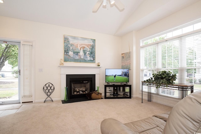 living room with ceiling fan, light colored carpet, vaulted ceiling, and a wealth of natural light