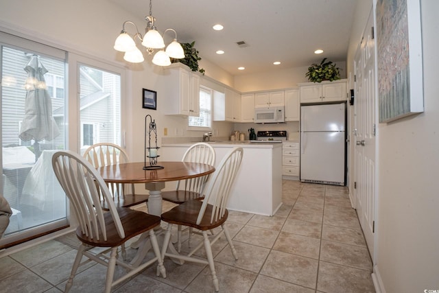 dining area with light tile patterned floors and a chandelier