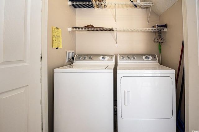 laundry room with washing machine and clothes dryer