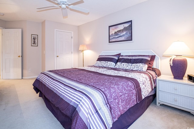 bedroom featuring light carpet and ceiling fan