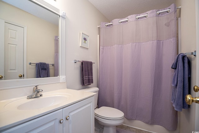 bathroom featuring vanity, toilet, and a textured ceiling