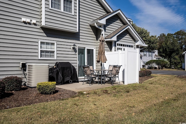 back of property featuring a yard, central AC, and a patio area