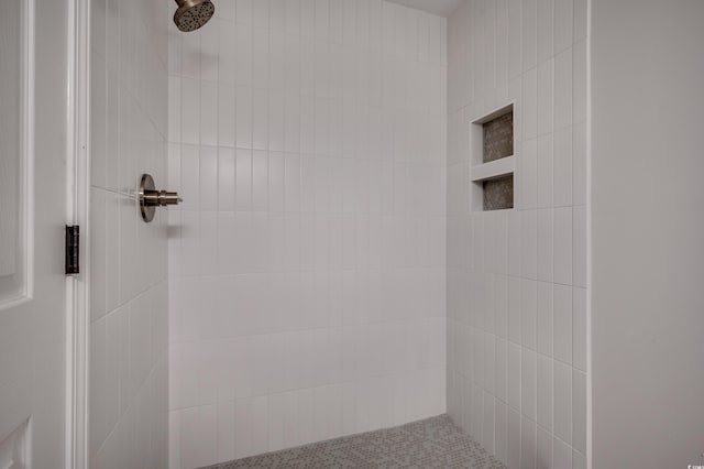 bathroom with a tile shower