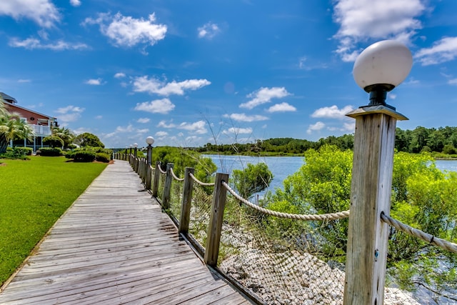 dock area featuring a lawn and a water view