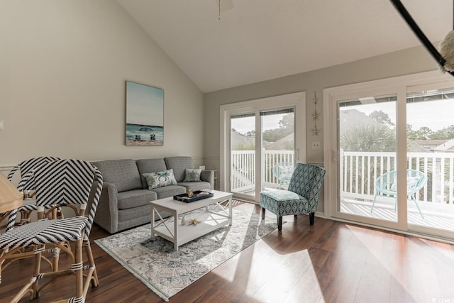 living room featuring high vaulted ceiling and hardwood / wood-style floors