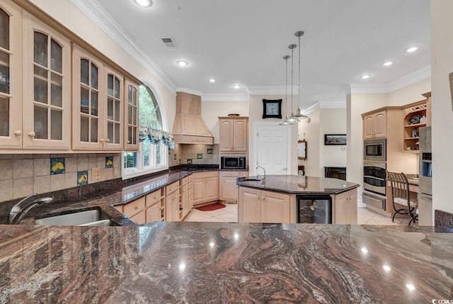 kitchen featuring a kitchen island, custom exhaust hood, hanging light fixtures, black appliances, and light brown cabinets