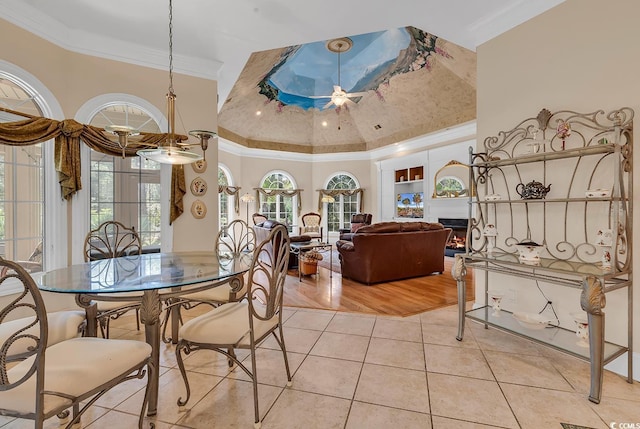 dining space featuring ornamental molding and light tile patterned floors