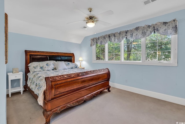 bedroom featuring ceiling fan, lofted ceiling, and light carpet