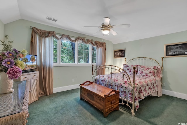 bedroom with dark carpet, vaulted ceiling, and ceiling fan