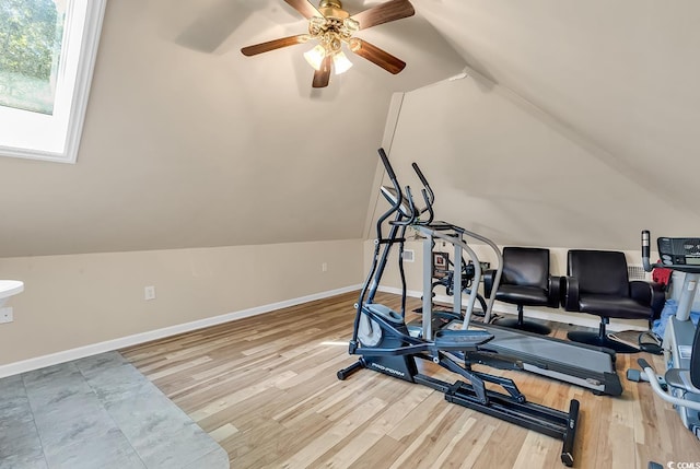 workout room featuring ceiling fan, lofted ceiling, and light wood-type flooring