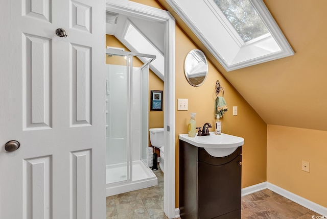 bathroom featuring vanity, lofted ceiling with skylight, a shower with door, and toilet