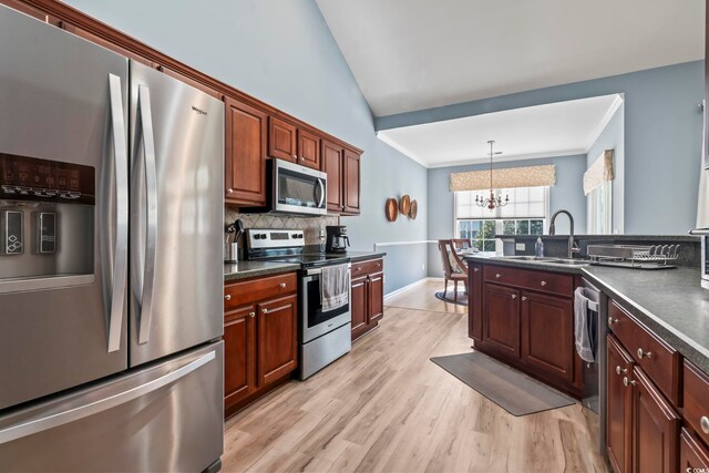 kitchen with sink, appliances with stainless steel finishes, backsplash, high vaulted ceiling, and light hardwood / wood-style flooring