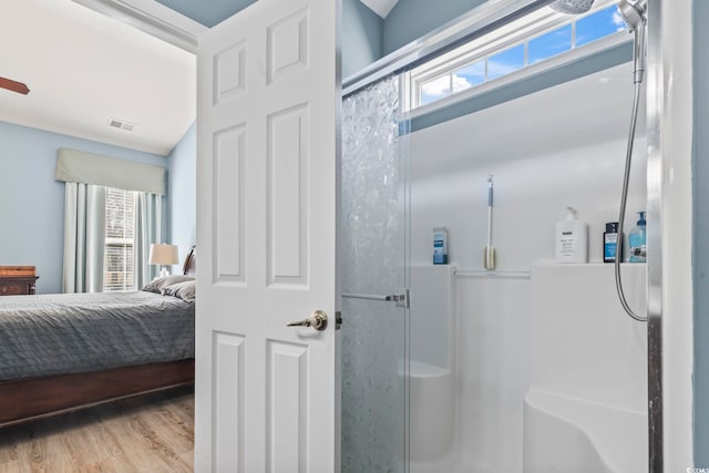 bathroom featuring walk in shower, hardwood / wood-style floors, vanity, and toilet