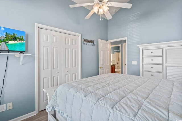 bedroom with hardwood / wood-style floors, lofted ceiling, ceiling fan, and a closet