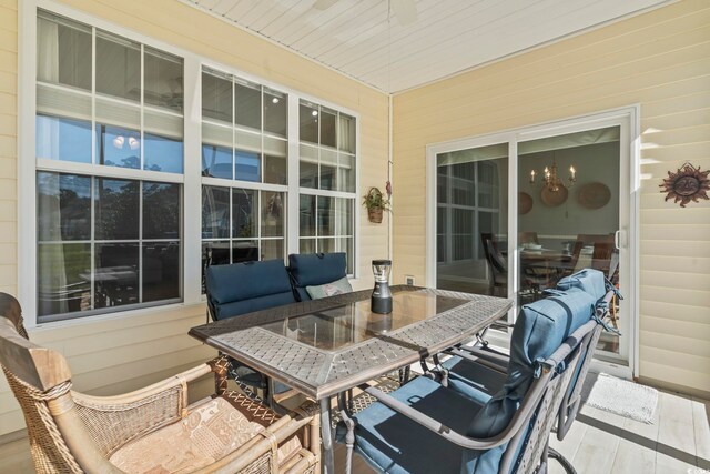 sunroom / solarium featuring ceiling fan