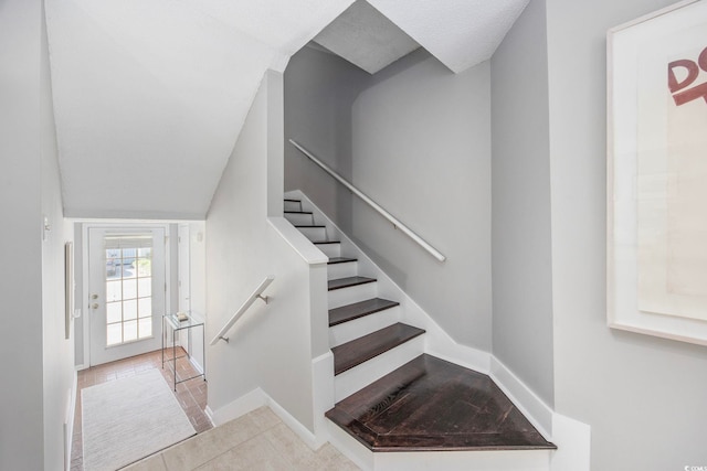 staircase featuring tile patterned floors