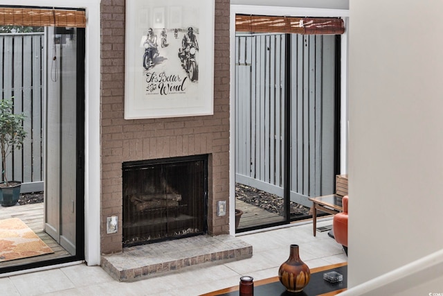 tiled living room featuring a brick fireplace