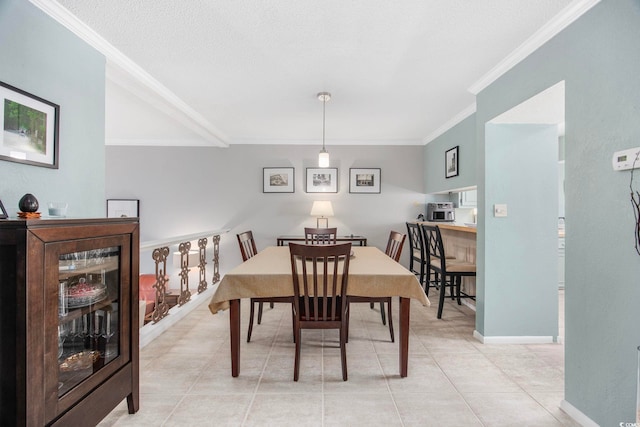 tiled dining area featuring crown molding and a textured ceiling