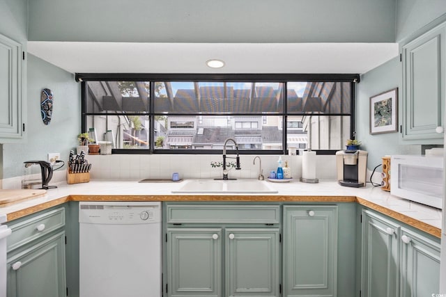 kitchen featuring white appliances and sink