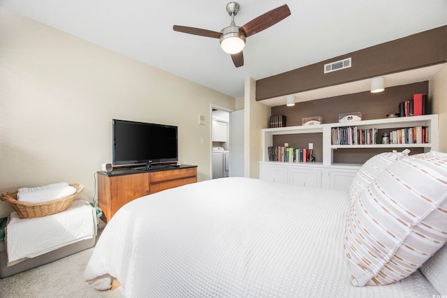 carpeted bedroom featuring washer / dryer and ceiling fan