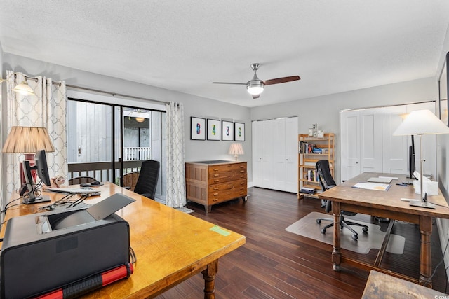 home office with a textured ceiling, dark hardwood / wood-style floors, and ceiling fan