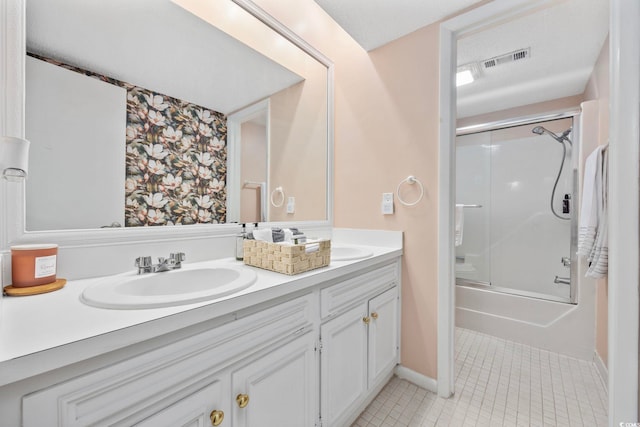 bathroom with shower / bath combination with glass door, tile patterned flooring, vanity, and a textured ceiling