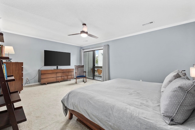 bedroom with ceiling fan, crown molding, carpet floors, and a textured ceiling