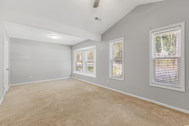 carpeted empty room featuring ceiling fan and vaulted ceiling