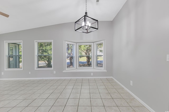 tiled spare room with a notable chandelier, plenty of natural light, and vaulted ceiling